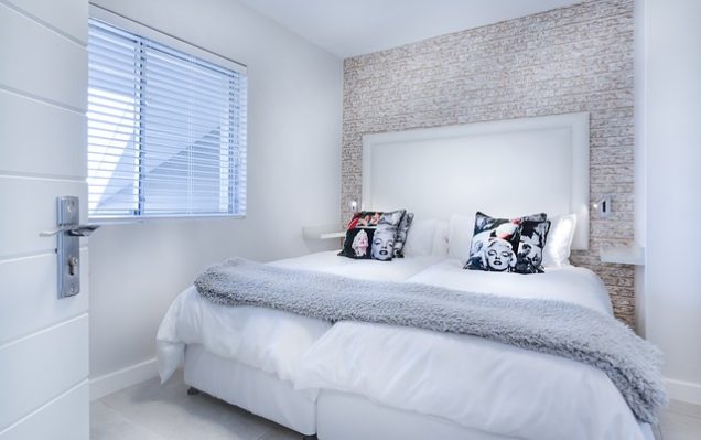 Apartments in San Antonio near Six Flags Fiesta         A white bedroom with a bed and pillows.