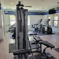 Apartments in San Antonio near Six Flags Fiesta A gym room with exercise equipment and a television.